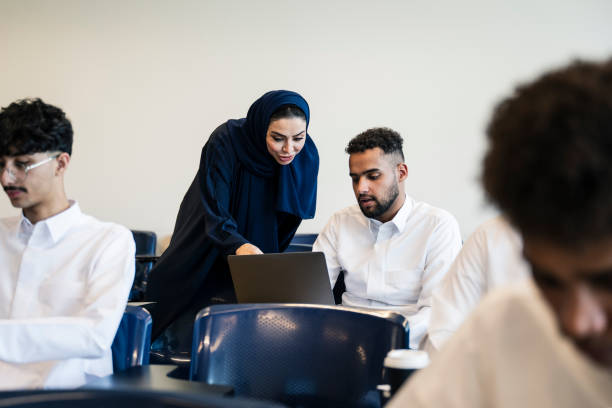 istock Female educator in traditional clothing assisting student 2152729241
