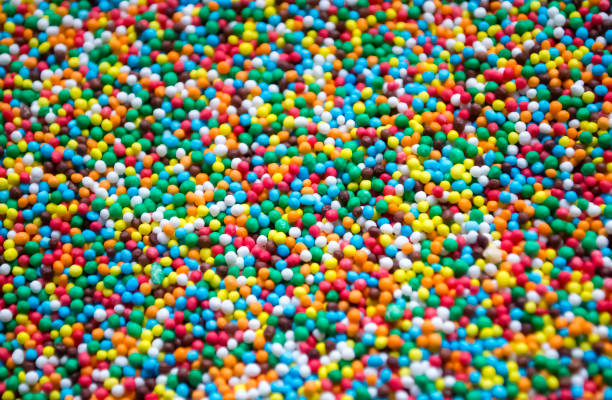Colored Easter powder. Lots of colored candies, top view. The background is small sugar candies multicolor.