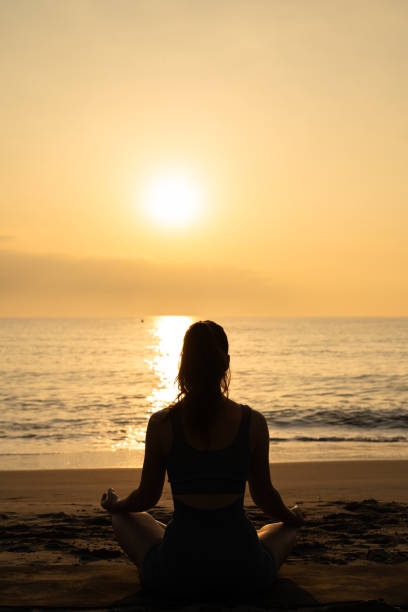 istock meditation and yoga on the beach. 2152729480