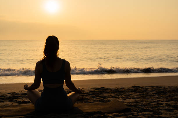 istock meditation and yoga on the beach. 2152729486