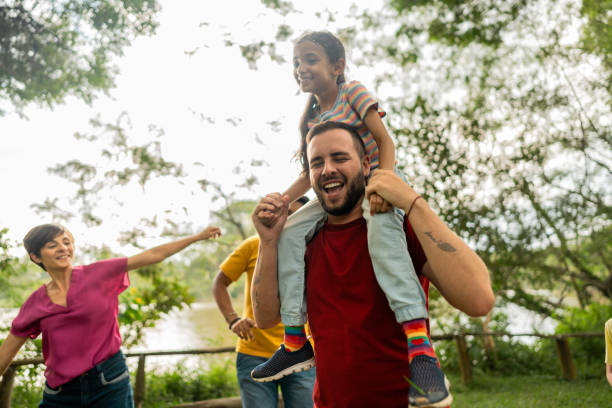 istock Step-father having fun during piggyback with adopted daughter on a public park 2152730879