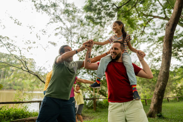 istock Step-father having fun during piggyback with adopted daughter on a public park 2152730897