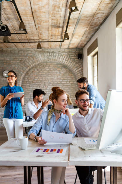 Group of young multi-ethnic startup business team collaborating on project in modern office