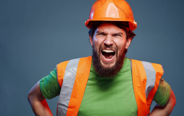 istock Male worker in orange paint emotions construction studio 2152733167