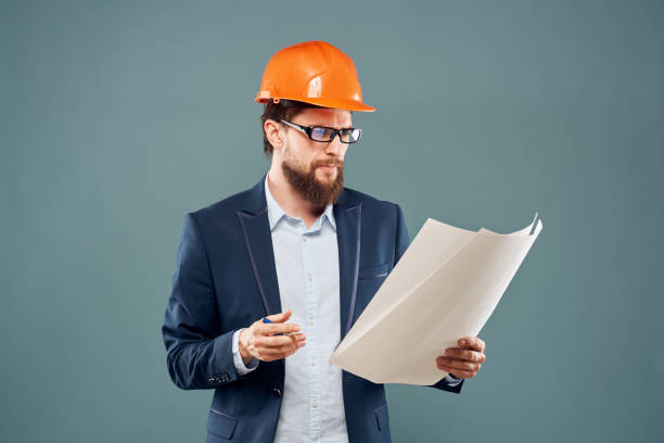 istock Engineer in orange paint job industry professional construction blue background 2152733312