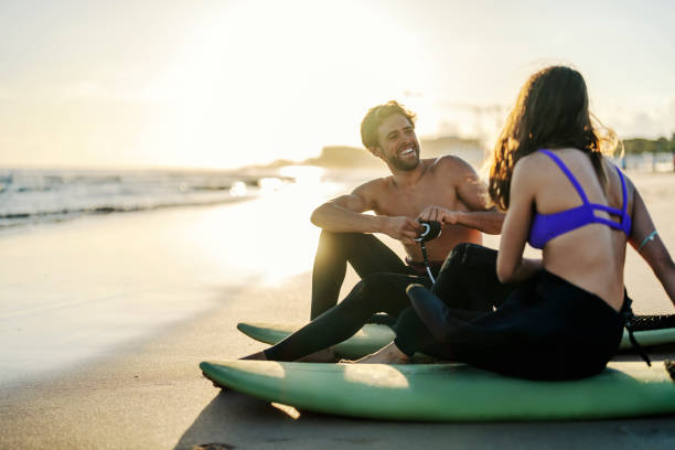 istock Happy surfers sitting on surfboards on a shore. 2152733357