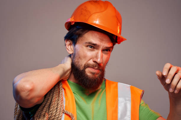 istock man in construction uniform orange hard hat construction cropped view 2152733993