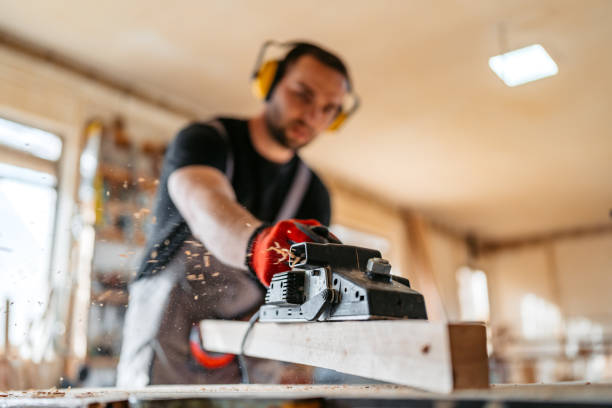 istock Young Male Carpenter Sanding The Wood In His Workshop 2152734118