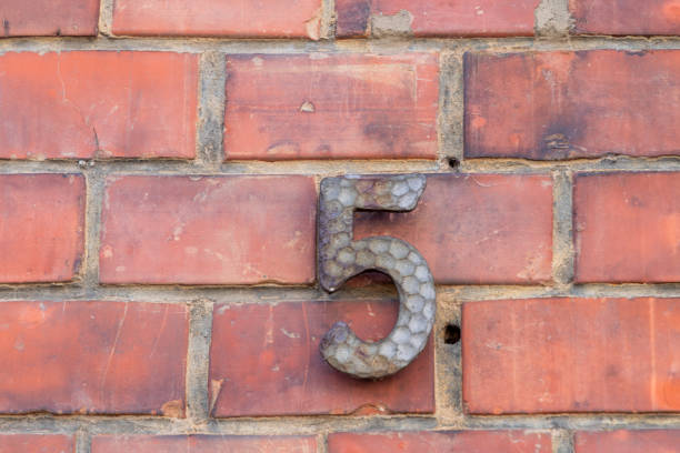 house number five at an old brick wall in Germany