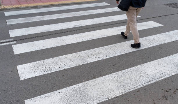 istock Low section of woman walking on zebra crossing 2152744867