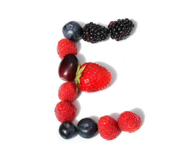istock letter E  made from raspberry, strawberries, blackberry, blueberries, grape. isolated berries letter for party 2152745142