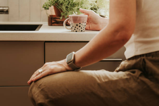 istock Woman at home indoors in her kitchen drinking coffee 2152745687