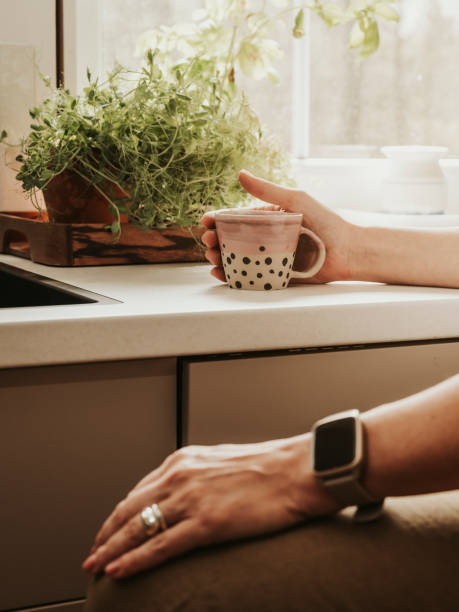 istock Woman at home indoors in her kitchen drinking coffee 2152745772