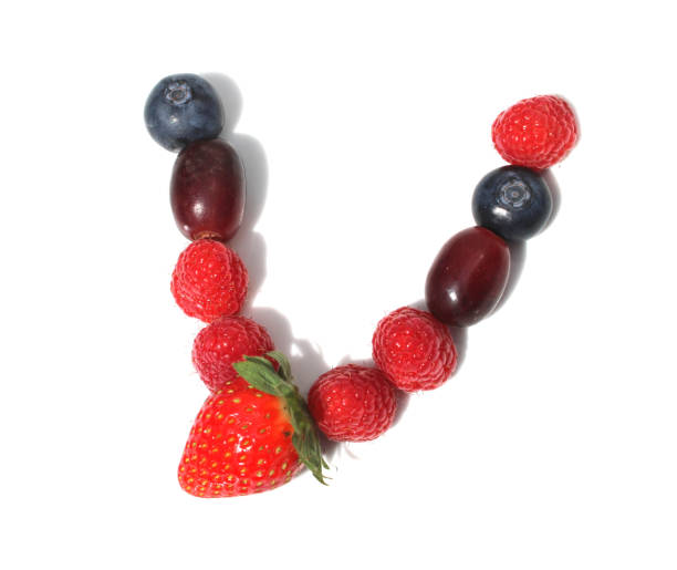 istock letter V made from raspberry, strawberries with green leaf, blueberries, grape. isolated berries letters for party 2152745773