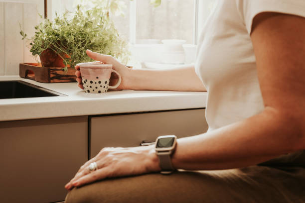 istock Woman at home indoors in her kitchen drinking coffee 2152745844