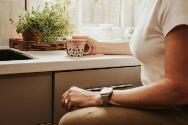 istock Woman at home indoors in her kitchen drinking coffee 2152745889