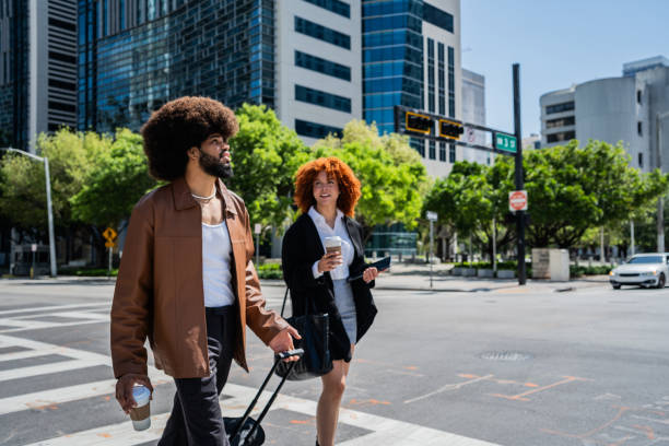 istock Young coworkers talking and walking through the city 2152746208