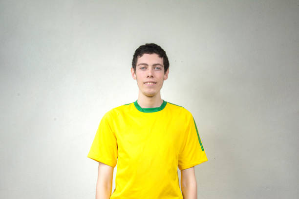 Man with yellow t-shirt and gray background
