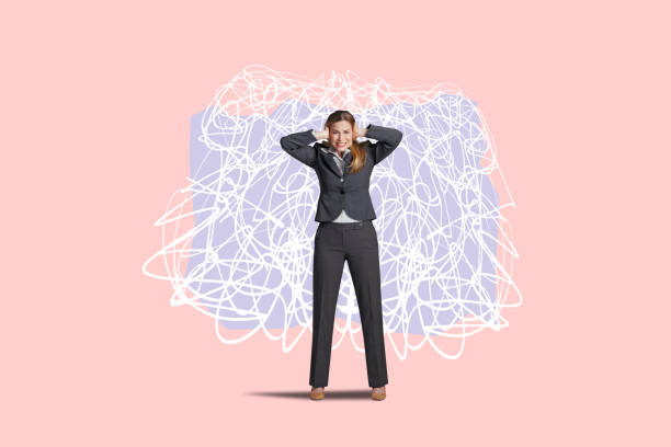 A woman covers her ears as she as she stands in front of some randomly drawn scribbled lines that convey the sense of confusion and chaos.