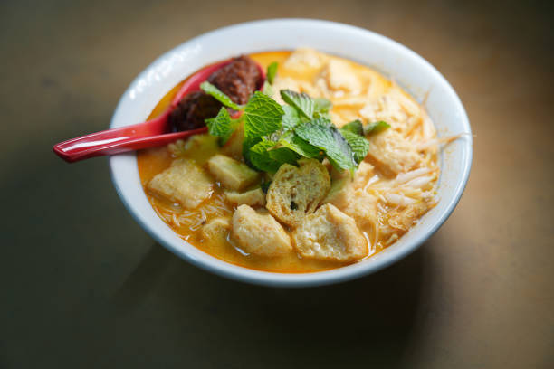 istock Penang's famous curry soup noodle served in a bowl at a hawker stall. 2152749399