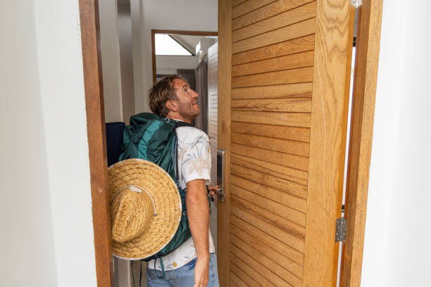 istock Man with Backpack Entering House Through Wooden Door 2152749822