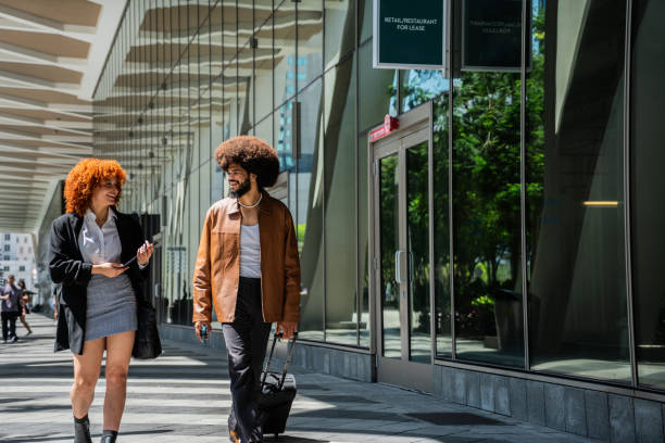 istock Young coworkers talking and walking through the city 2152750036