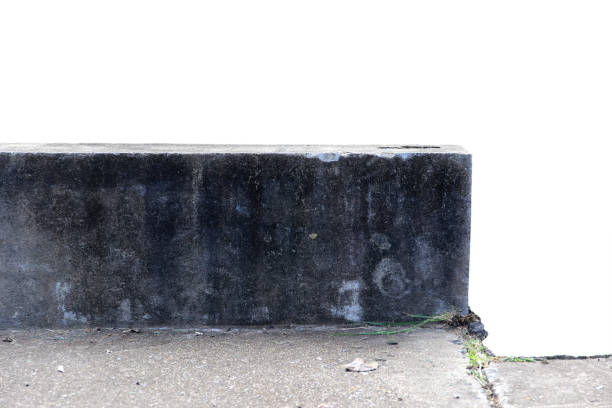 istock The old cement wall is broken, cracked, and damaged isolated on white background with clipping path. 2152751848