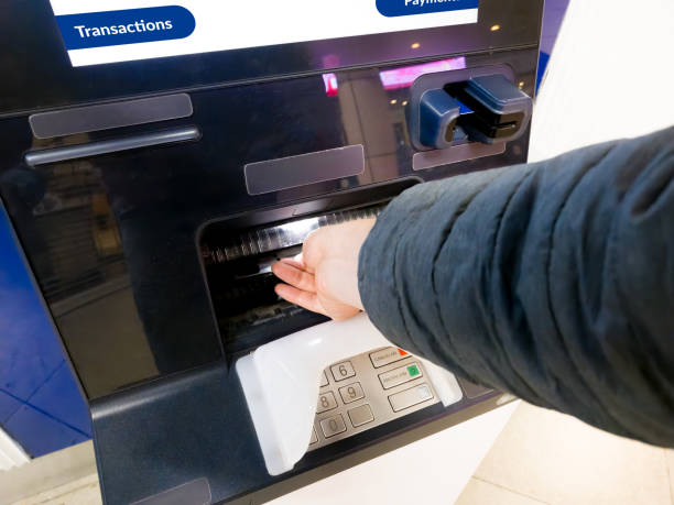 istock person withdrawing money at an ATM 2152751876