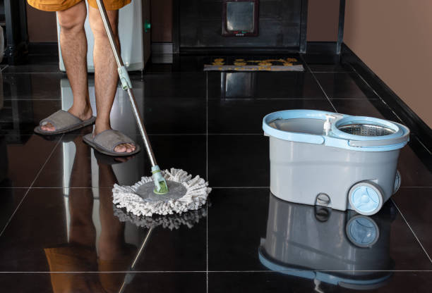 istock Man mopping floor and mopping bucket on the floor 2152753317