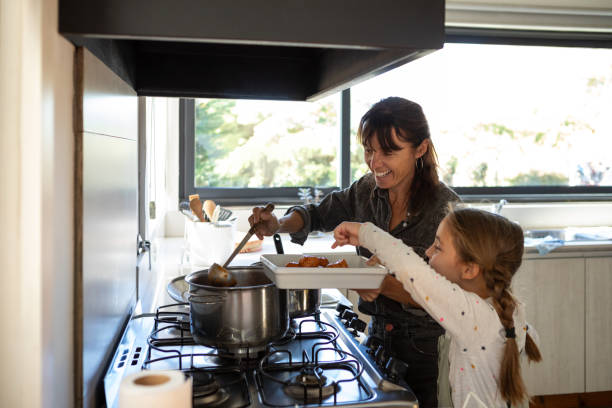 istock Hispanic American mother and daughter preparing lunch 2152755427