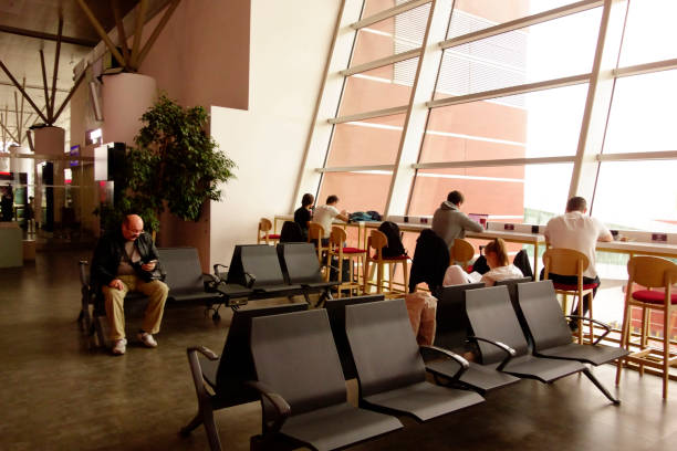 Girl  is sitting while waiting at the airport