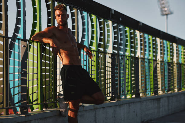 istock Shirtless handsome man rests after workout on a hot sunny day 2152755815