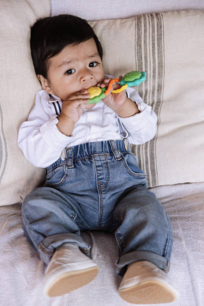 istock Relaxed baby boy teething on colorful toy. 2152756465