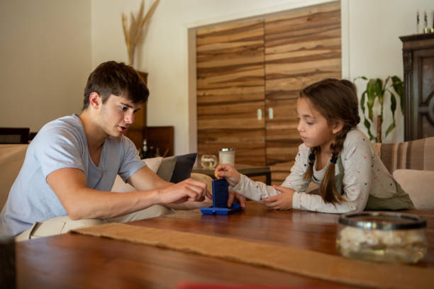 istock Hispanic American brothers playing a board game 2152756571