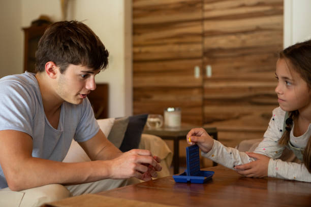 istock Hispanic American brothers playing a board game 2152756578