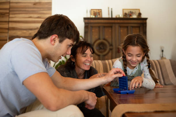 istock Hispanic American brothers playing a board game 2152756595