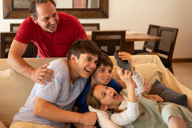 istock Hispanic American father and children taking a selfie 2152756690