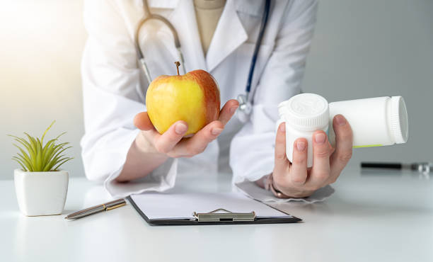 istock Apple vs. drugs in doctor's hands. Healthy choice concept 2152757585