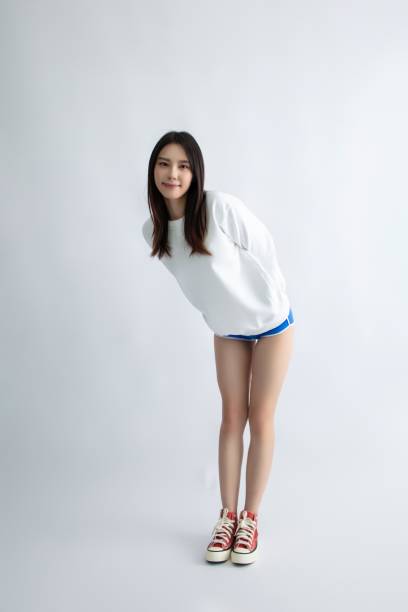 Cheerful Asian school girl bowing