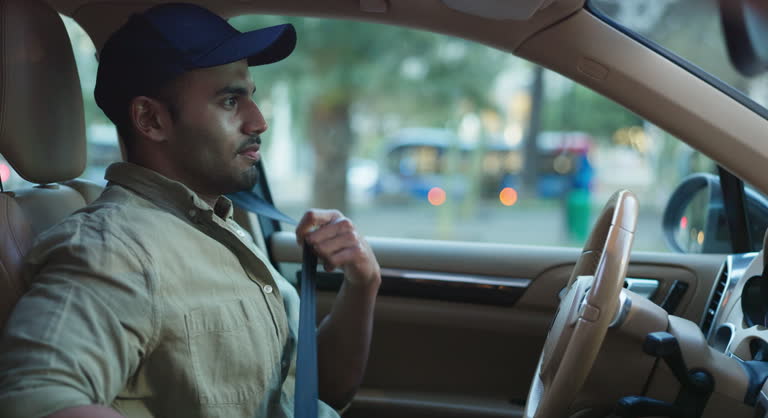 Man, car and seatbelt for safety with drive to work with protection in traffic to avoid accident. Security, travel and vehicle with journey for vacation in London with rental for road trip on break