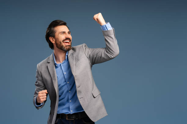 istock Young businessman over isolated blue background celebrating a victory, posing in studio 2152761590