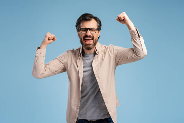 istock Excited man in casual and glasses, winning something, posing in studio, isolated on blue 2152761697