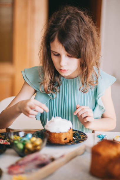 istock A girl decorates traditional Ukrainian pastries for Easter. 2152761790