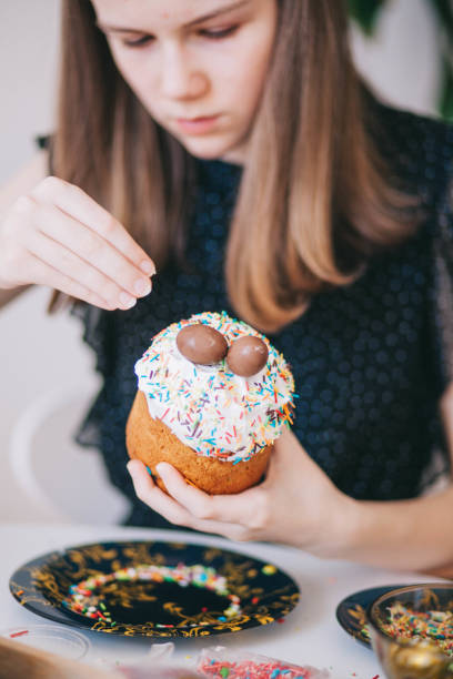 istock A girl decorates traditional Ukrainian pastries for Easter. 2152761809