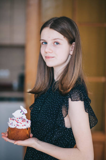 istock A girl decorates traditional Ukrainian pastries for Easter. 2152761838