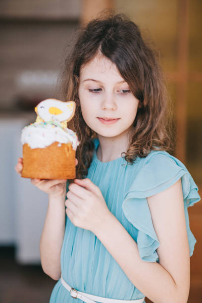 istock A girl decorates traditional Ukrainian pastries for Easter. 2152761873