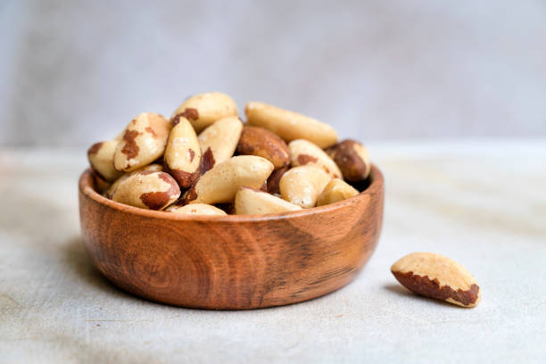 istock Brazil nut in wooden bowl 2152763629