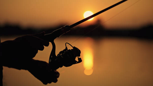 istock Man fishing at lake during sunset. 2152765293
