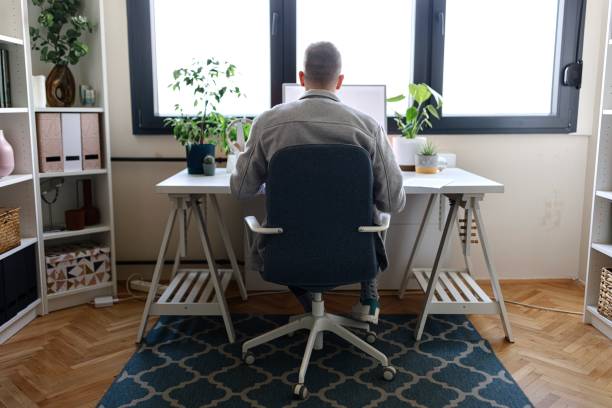 istock Rear view of a man working remotely 2152765870