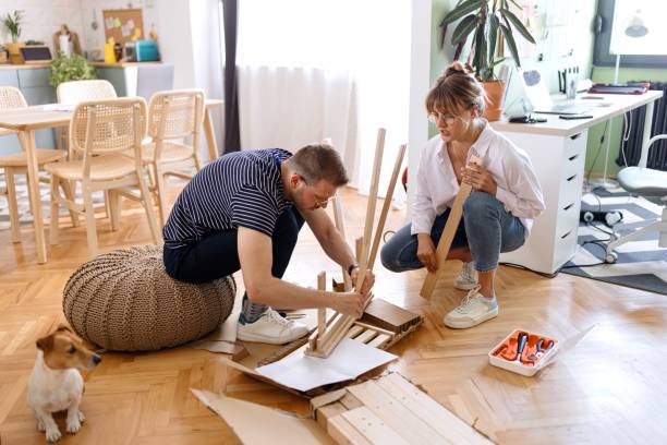 istock Couple engaged in the process of assembling a new table 2152765955